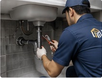Plumbing technician repairing sink
